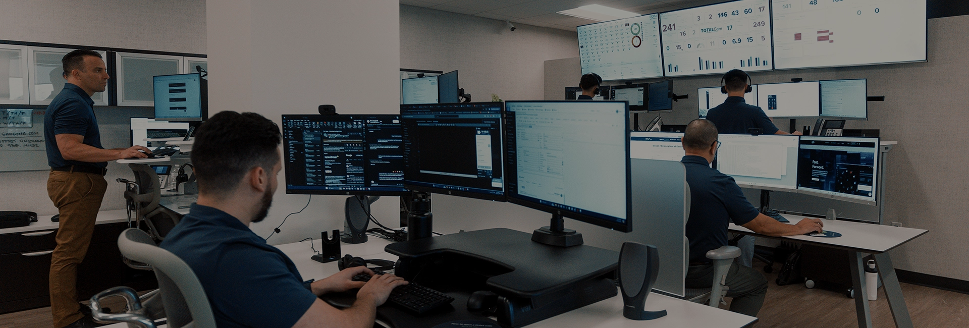 Person working on multiple monitors with financial data displayed, representing managed IT services tailored for accounting firms.