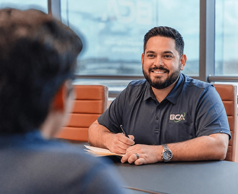 Dedicated account manager meeting with a client to review IT needs and technology planning.