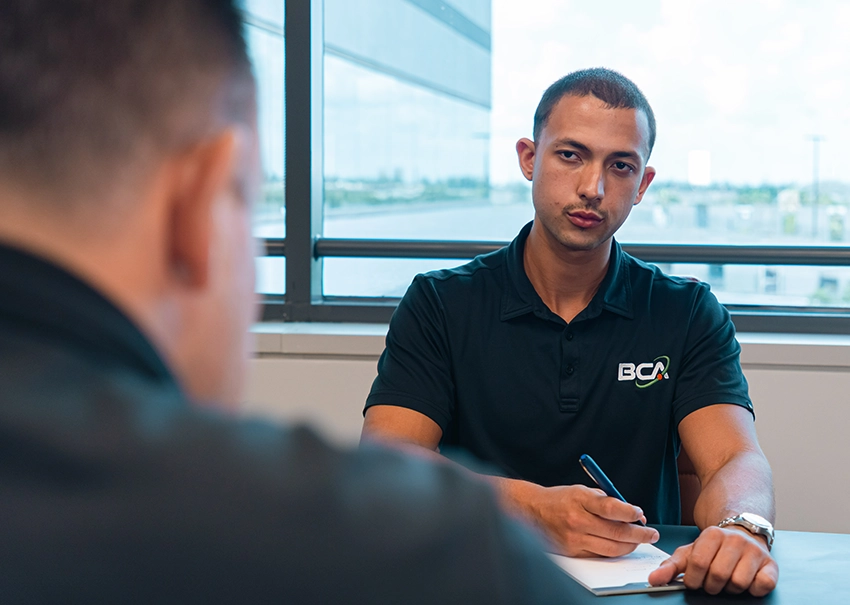 BCA IT consultant leading a business technology discussion.