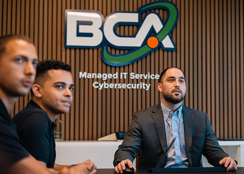 BCA IT leadership team discussing business strategy in a conference room.
