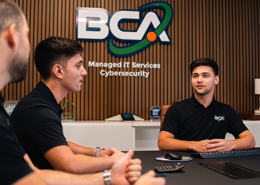 BCA IT professionals planning technology solutions during a team meeting.