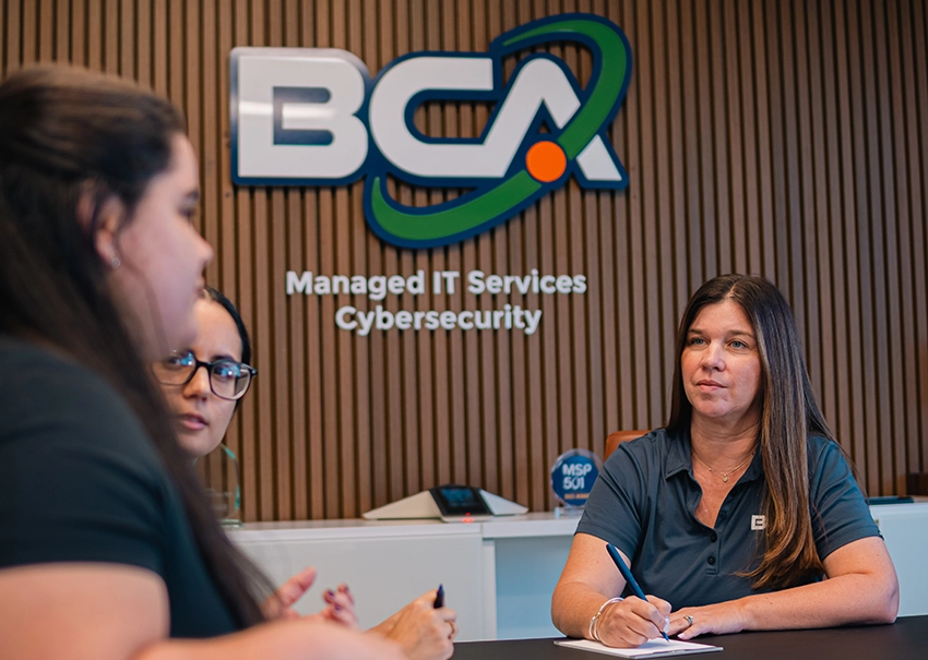 BCA IT team discussing business plans in a conference room.