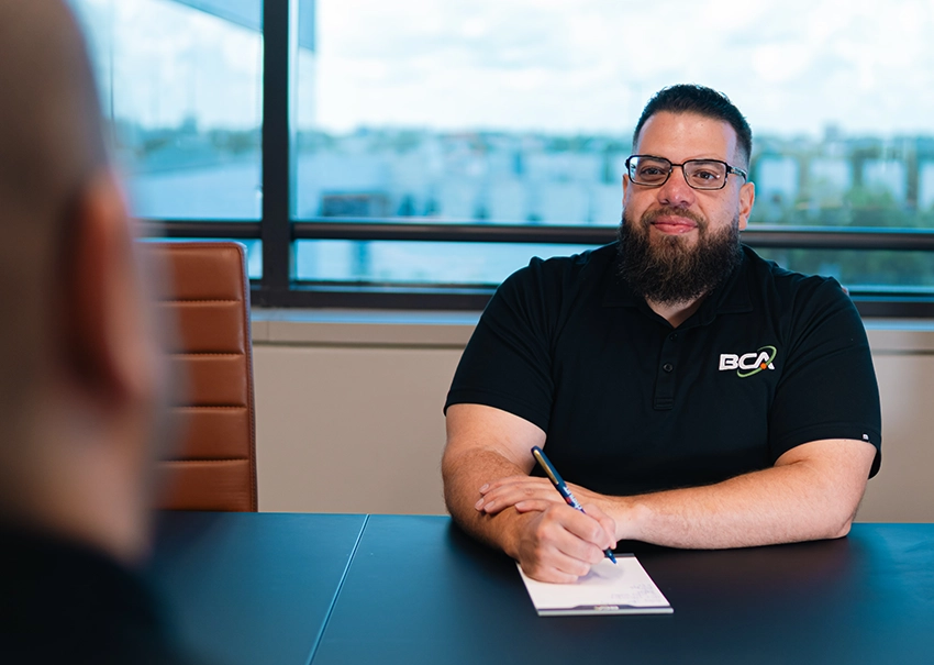 BCA IT consultant discussing technology needs during a client meeting.
