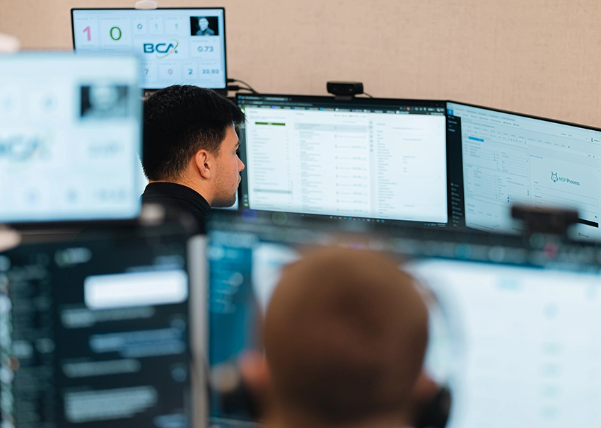 BCA IT team monitoring client systems across multiple screens.