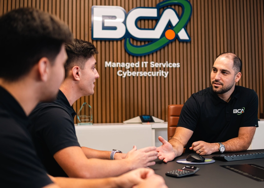 BCA IT team members discussing technology strategy at a conference table.