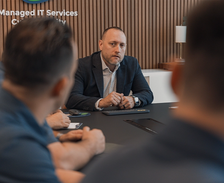 BCA manager leading a discussion with staff during a conference room meeting.